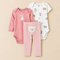 Set of baby clothing including a pink long-sleeve bodysuit, white and gray patterned onesie, and pink and white striped pants on a white background.