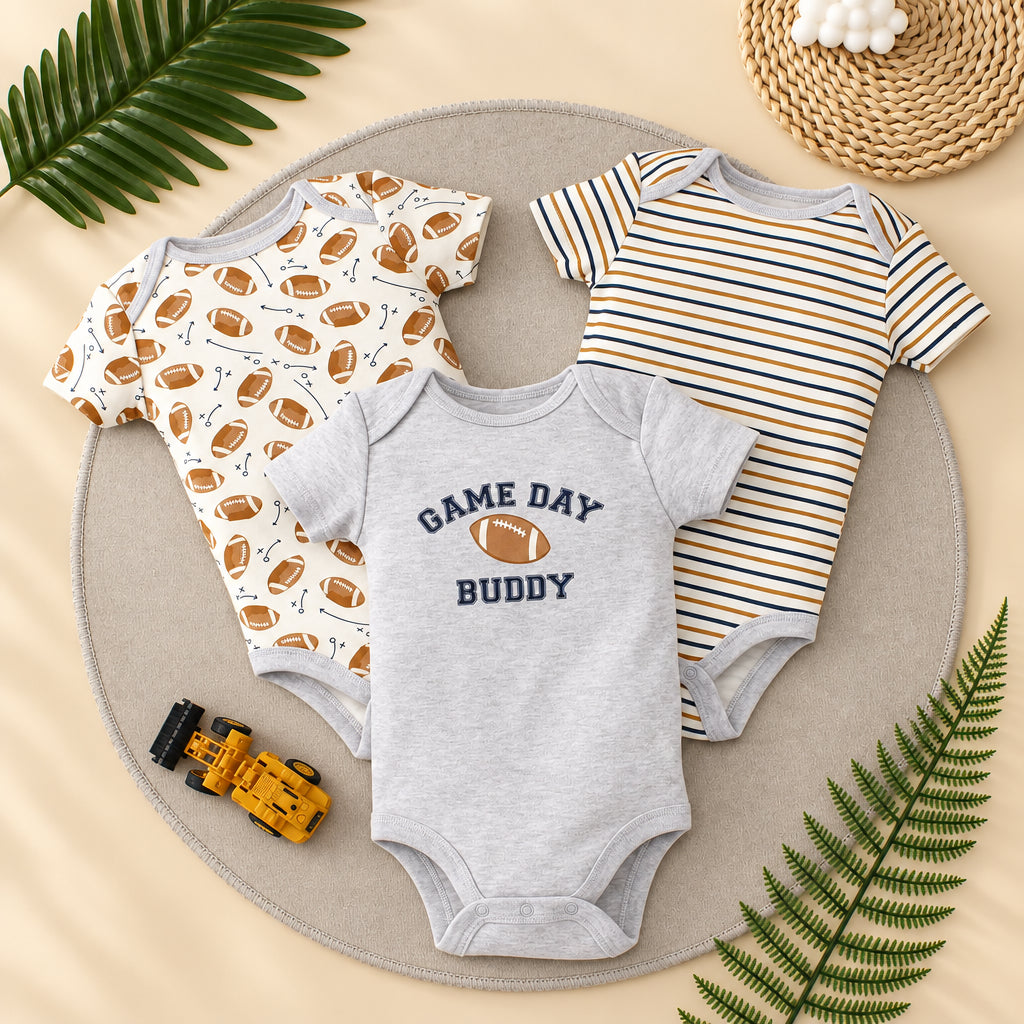 Three baby bodysuits on a round gray surface with decorative elements.