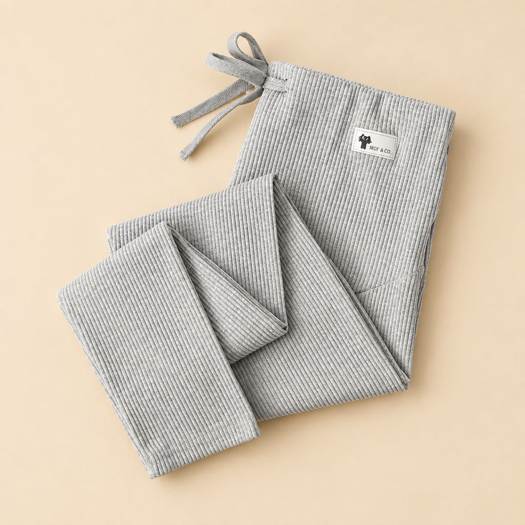 Gray checkered pants with a label on a white surface