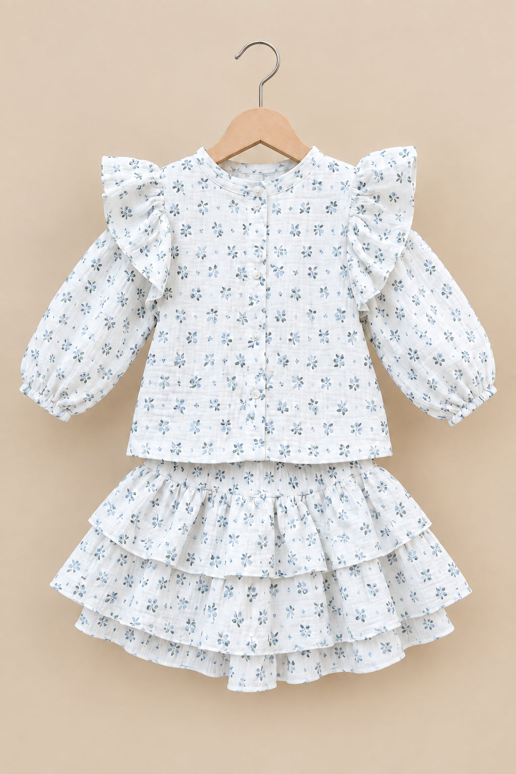 White floral dress with puffed sleeves on a hanger against a neutral background