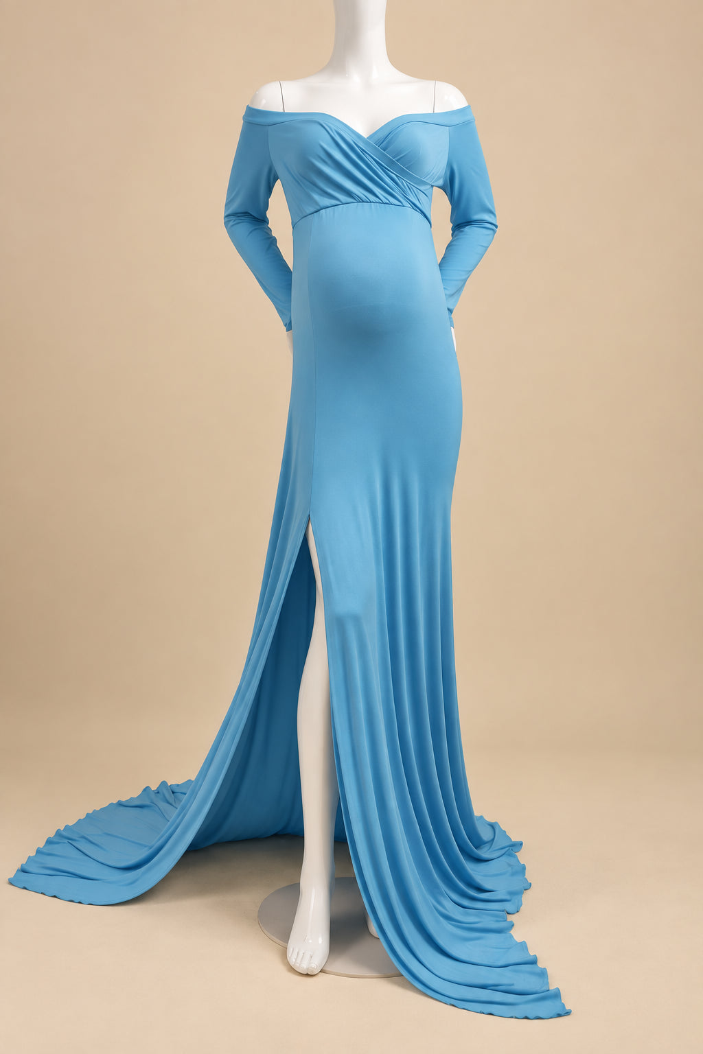 A light blue off-the-shoulder maternity gown with long sleeves, a sweetheart neckline, and a high leg slit, displayed on a white mannequin with a matching train on a white rug.