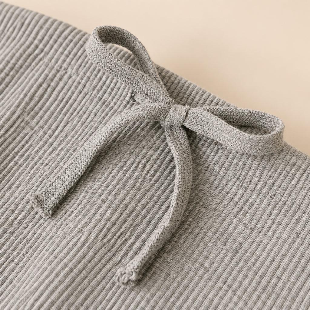 Gray textured fabric with a bow detail on a light background