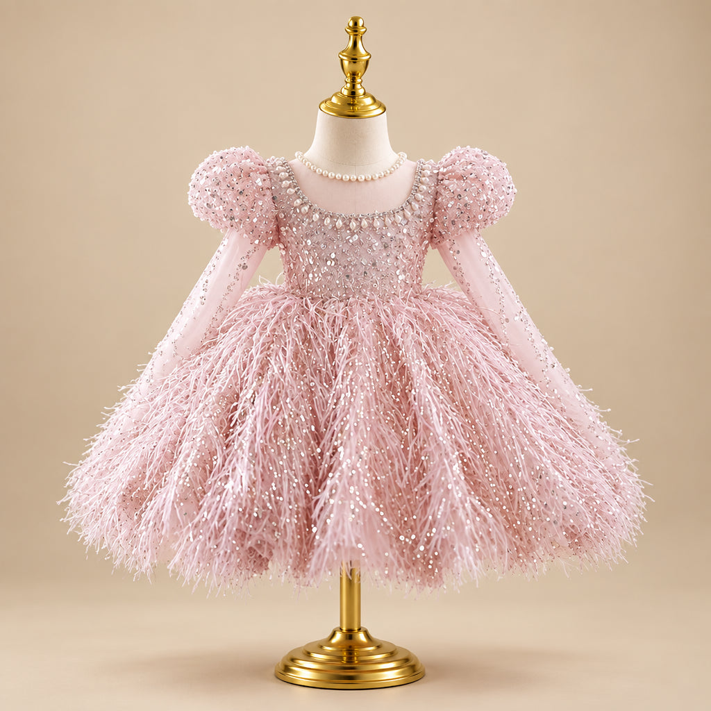 Pink dress with feathered skirt on a mannequin against a blurred indoor background