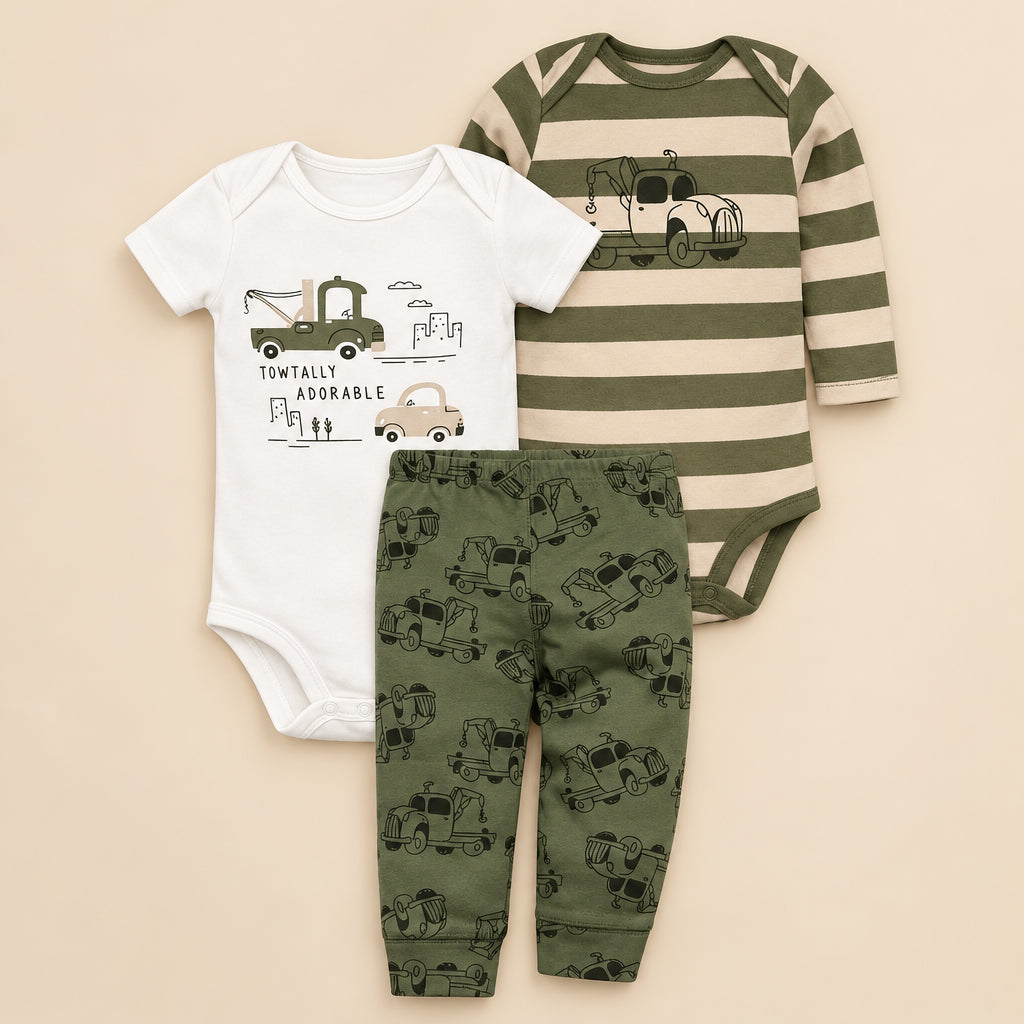 Set of baby clothing with green and white striped onesie, white shirt with truck design, and green pants with truck pattern on a white background.