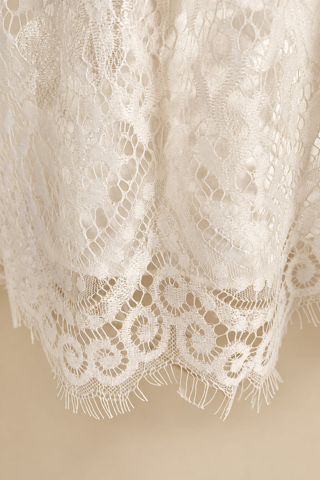 Close-up of white lace fabric with intricate patterns