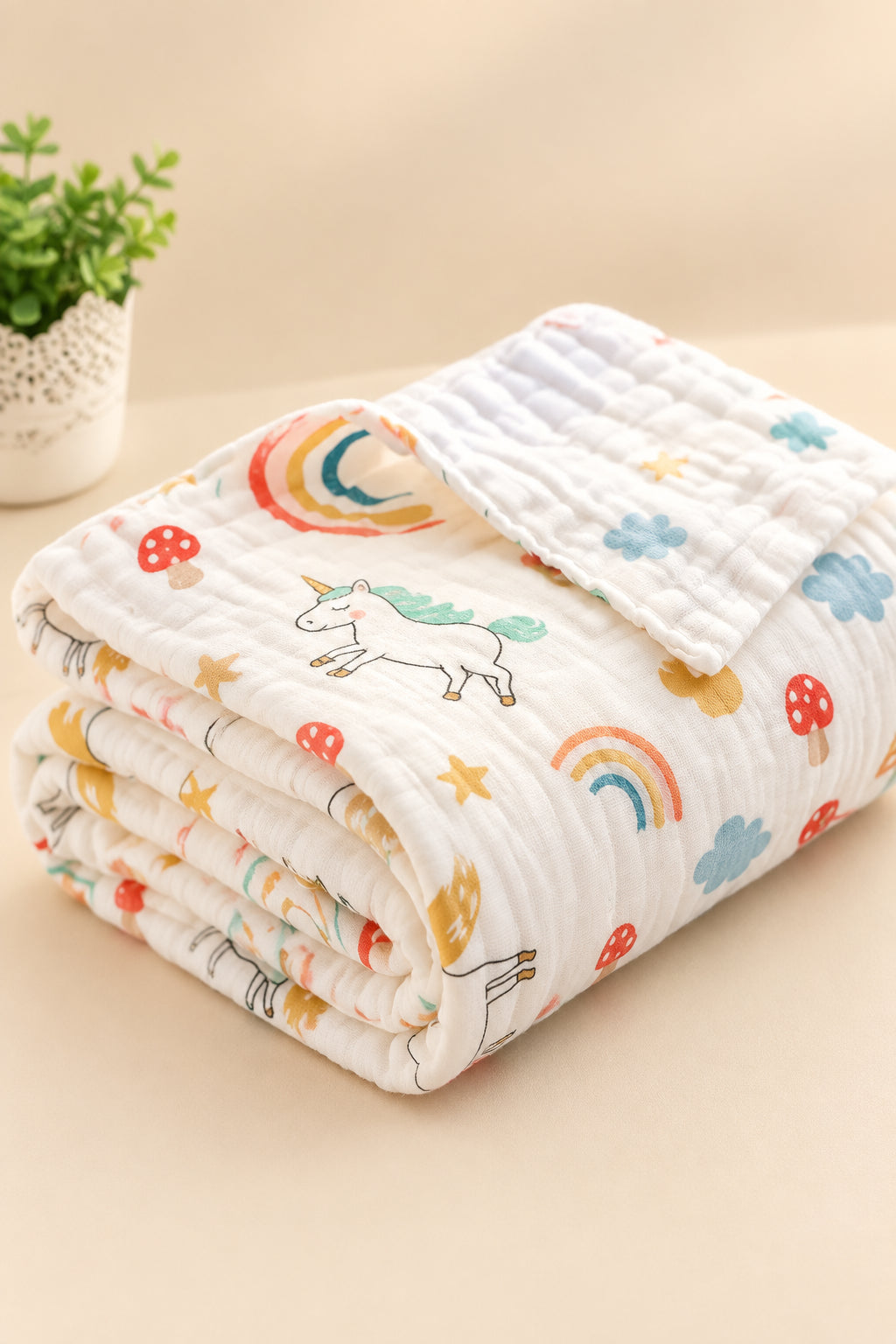 Folded baby blanket with cartoon designs on a white surface