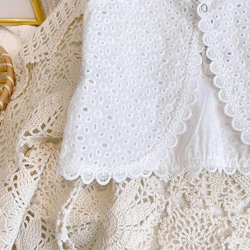 Close-up of white lace fabric with a textured background